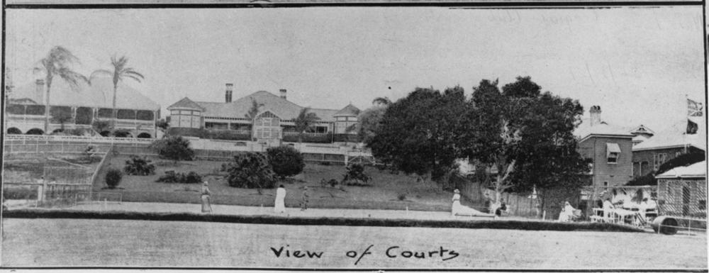 Croquet courts at New Farm, Brisbane, 1921. Four women play while spectators watch from the seats.