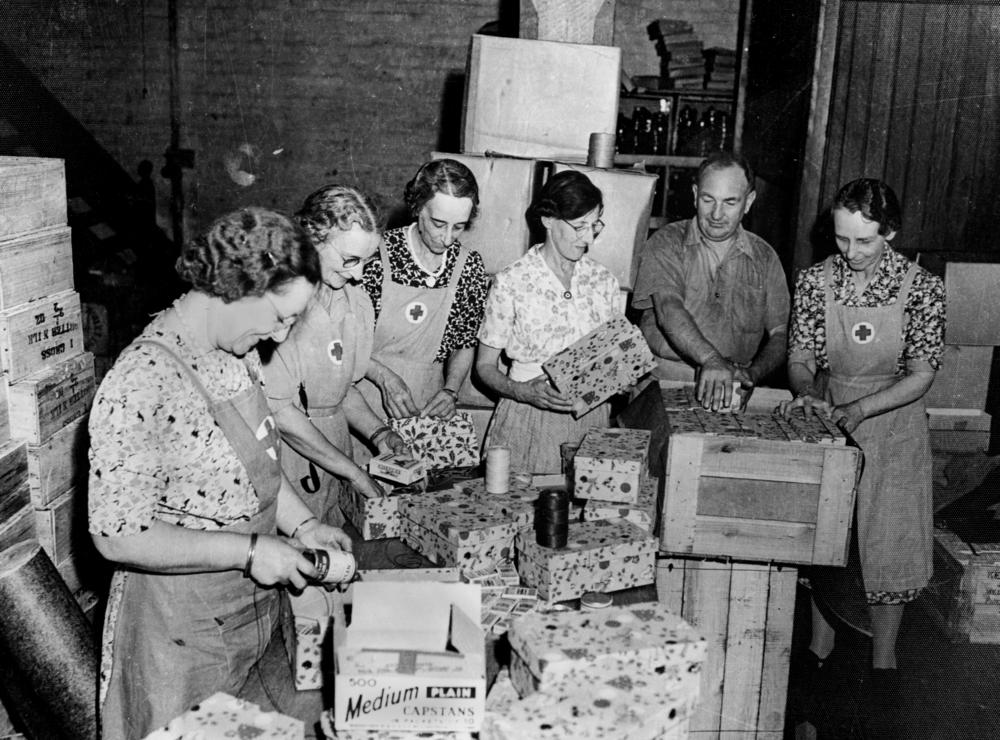 Red Cross workers in Brisbane packing Christmas parcels for the forces, 26 October 1942.