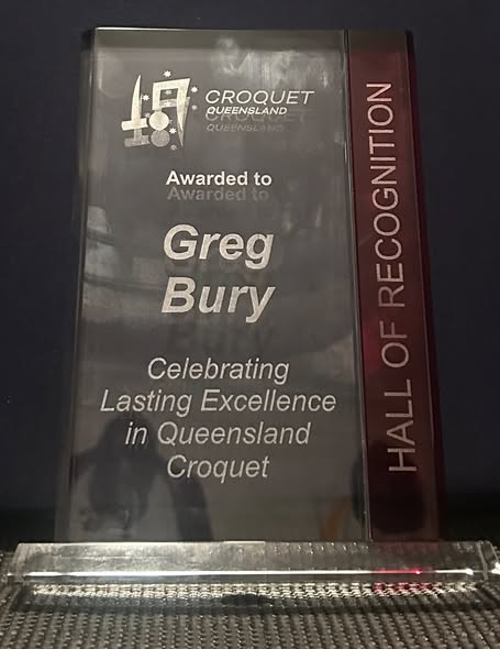A glass award plaque for Greg Bury from Croquet Queensland Hall of Recognition for lasting excellence in croquet