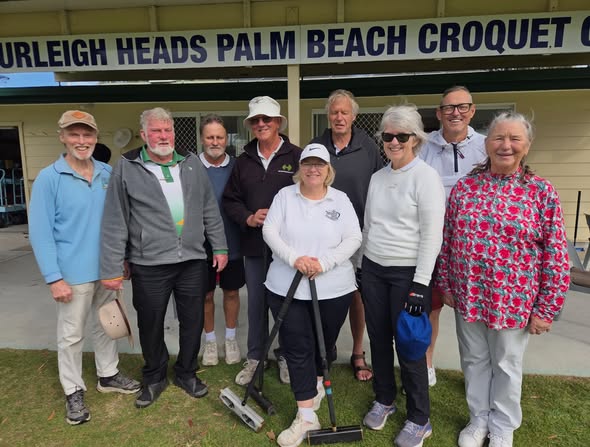A group of croquet players poses in front of the "Palm Beach Croquet Club" sign, with one woman holding a mallet